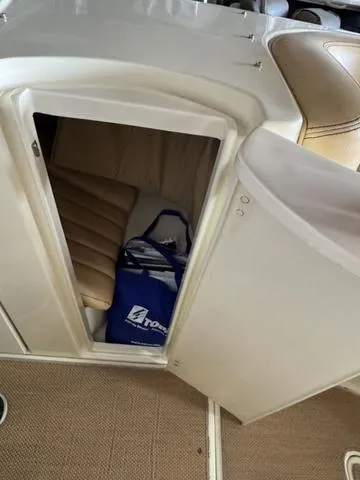 Slide: The Image of 2012 Chris-Craft Launch 28 cabin storage with blue tote bag inside. - 17