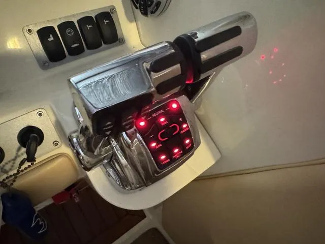 Slide: The Image of Chrome throttle controls on a 2012 Chris-Craft Launch 28 boat dashboard. - 19