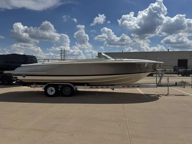 Slide: The Image of 2012 Chris-Craft Launch 28 boat on trailer under a partly cloudy sky. - 2