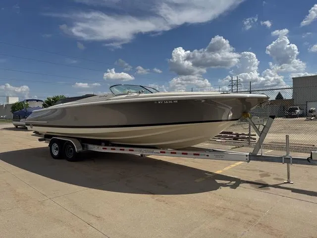 Slide: The Image of 2012 Chris-Craft Launch 28 boat on trailer under a partly cloudy sky. - 3