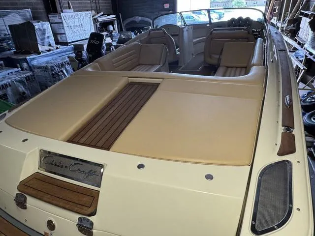 Slide: The Image of 2012 Chris-Craft Launch 28 boat with tan upholstery and wooden accents in a storage area. - 7