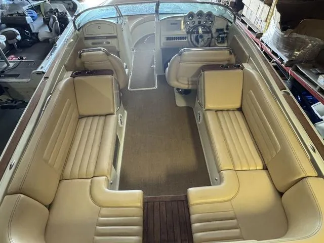 Slide: The Image of 2012 Chris-Craft Launch 28 interior with beige leather seating and classic dashboard design. - 8