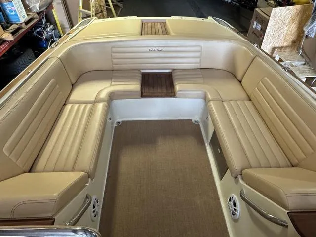 Slide: The Image of 2012 Chris-Craft Launch 28 boat interior with beige leather seating and wood accents. - 9