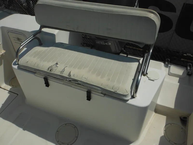 Slide: The Image of Worn seating on 2002 Robalo R235 Walkaround boat, showing visible wear and tear. - 11