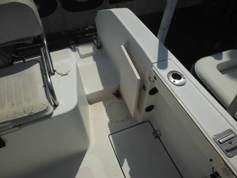 Slide: The Image of 2002 Robalo R235 Walkaround boat interior with seating and storage compartments. - 12