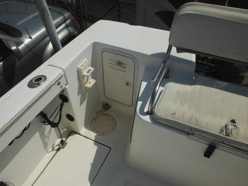 Slide: The Image of 2002 Robalo R235 Walkaround boat interior with seating and storage compartments. - 13