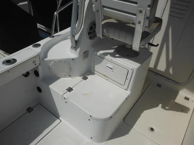 Slide: The Image of 2002 Robalo R235 Walkaround boat interior with seating and storage compartments. - 16