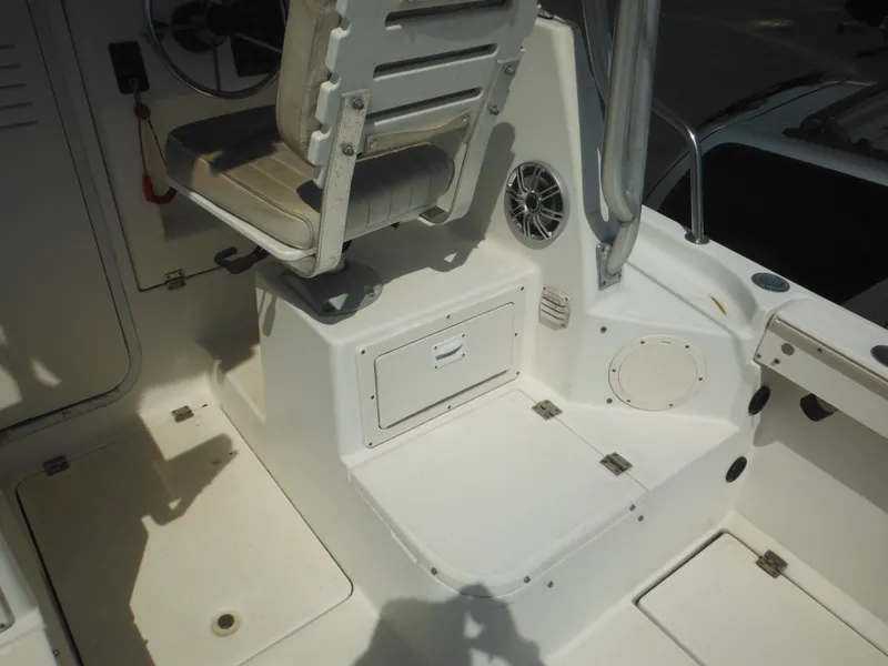 Slide: The Image of 2002 Robalo R235 Walkaround boat interior with seating and storage compartments. - 17