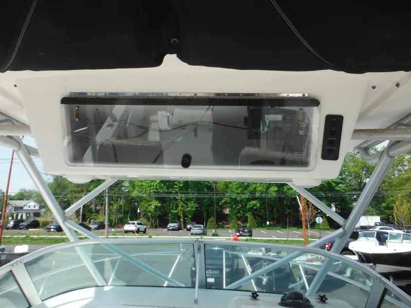 Slide: The Image of 2002 Robalo R235 Walkaround boat interior with overhead console and windshield view. - 20