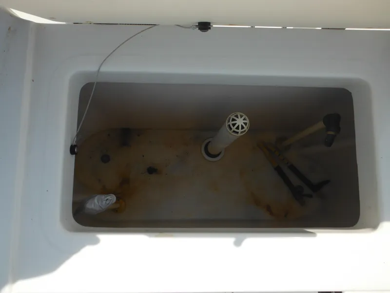 Slide: The Image of Livewell compartment of a 2002 Robalo R235 Walkaround boat, showing interior details. - 24