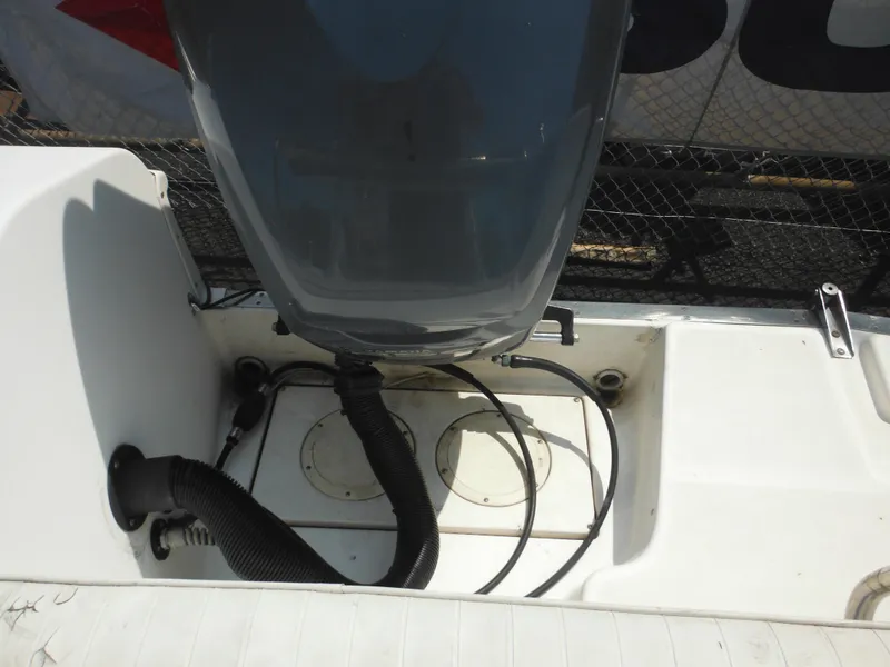 Slide: The Image of 2002 Robalo R235 Walkaround boat engine compartment with visible wiring and hoses. - 25