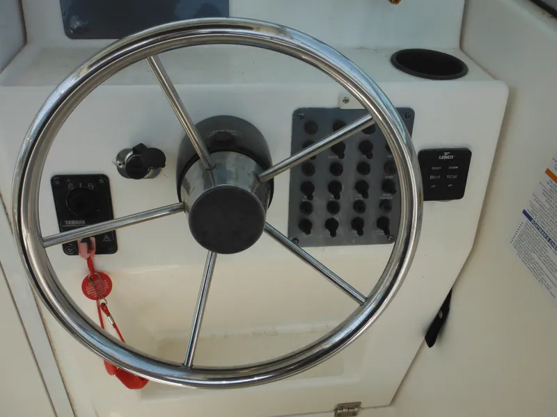 Slide: The Image of Steering wheel and controls of 2002 Robalo R235 Walkaround boat. - 27
