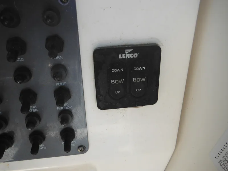 Slide: The Image of Control panel of a 2002 Robalo R235 Walkaround boat with Lenco trim tab switches. - 28