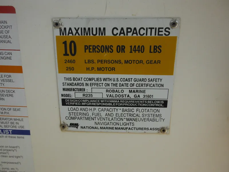 Slide: The Image of 2002 Robalo R235 Walkaround capacity plate: 10 persons or 1440 lbs, 250 HP motor. - 34