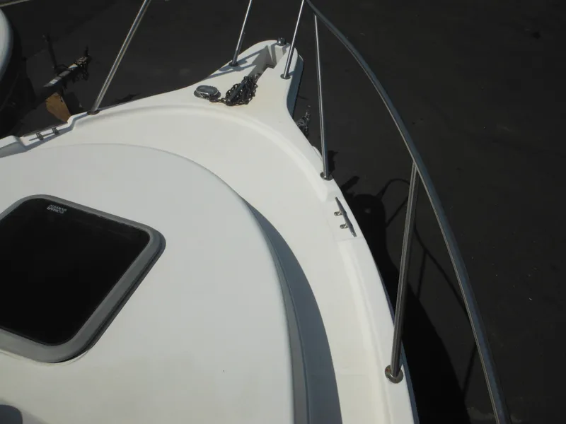 Slide: The Image of 2002 Robalo R235 Walkaround boat deck with railing and hatch. - 35