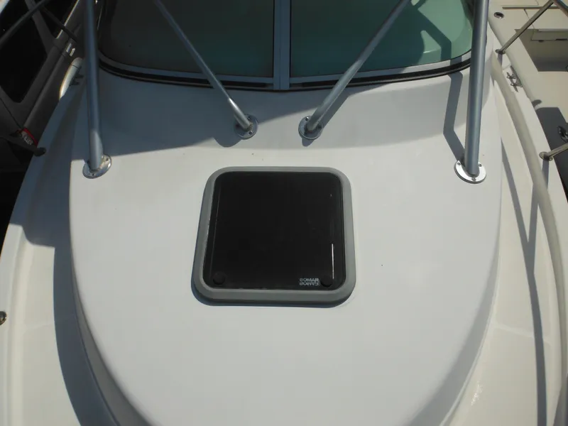 Slide: The Image of 2002 Robalo R235 Walkaround boat deck with hatch and railing. - 37