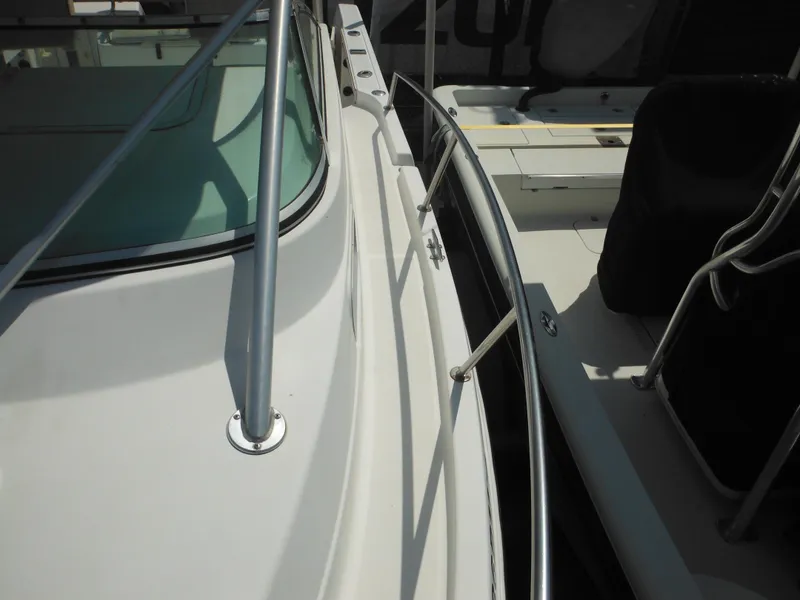 Slide: The Image of 2002 Robalo R235 Walkaround boat deck with railing and seating area. - 38