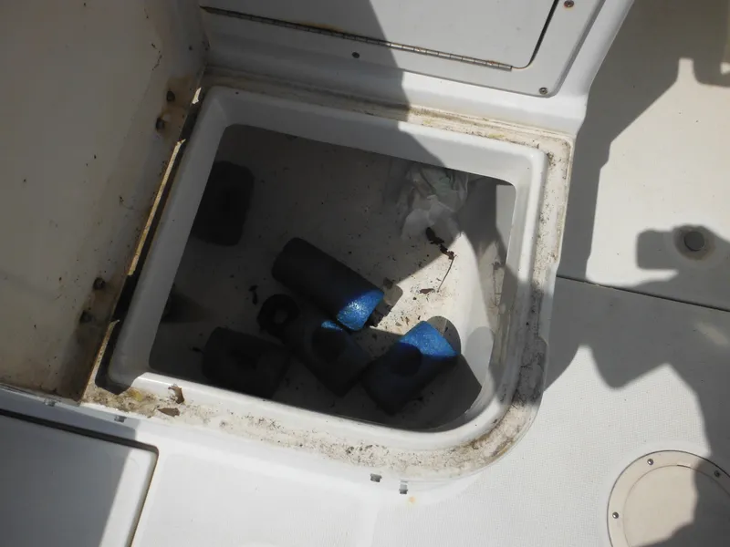Slide: The Image of Open storage compartment on 2002 Robalo R235 Walkaround boat with foam rollers inside. - 42