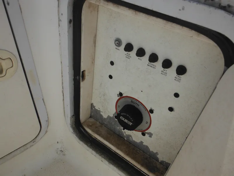 Slide: The Image of Control panel of a 2002 Robalo R235 Walkaround boat, featuring switches and a dial. - 45