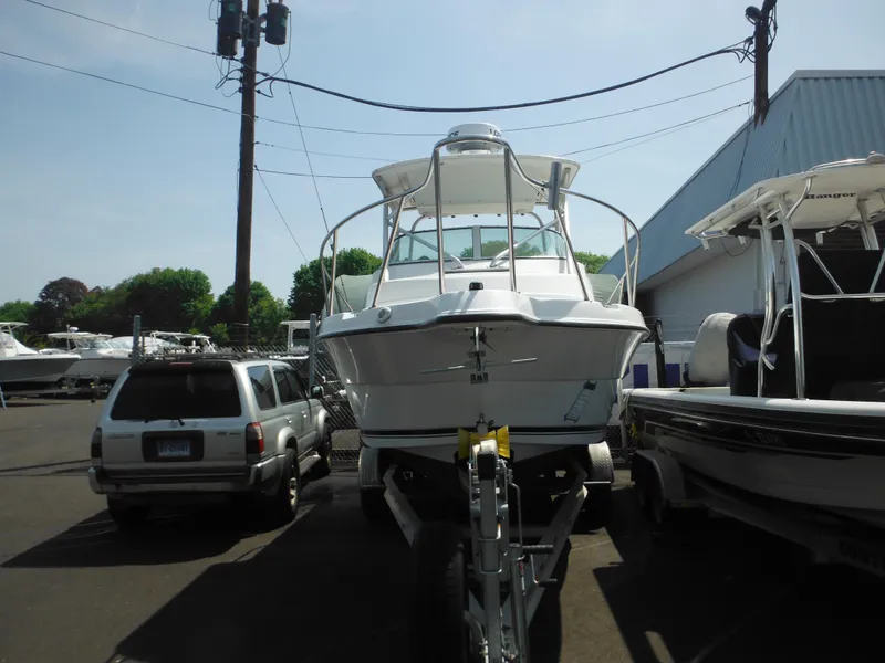 Slide: The Image of 2002 Robalo R235 Walkaround boat on trailer in marina parking lot. - 47