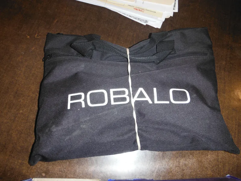 Slide: The Image of Black Robalo bag on wooden table, related to 2002 Robalo R235 Walkaround. - 49