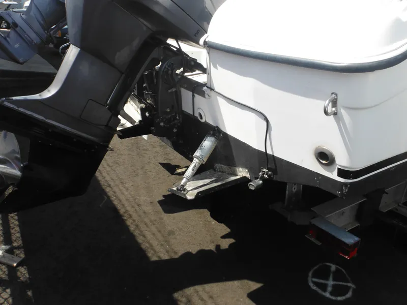 Slide: The Image of 2002 Robalo R235 Walkaround boat stern with outboard motor and trailer. - 5