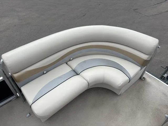 Slide: The Image of Curved seating on 2015 South Bay 420 CR boat, featuring beige and gray upholstery. - 10