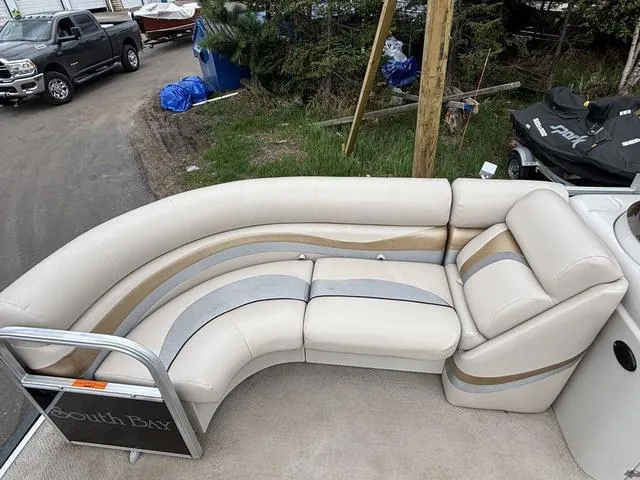 Slide: The Image of 2015 South Bay 420 CR boat with beige seating and silver accents. - 11