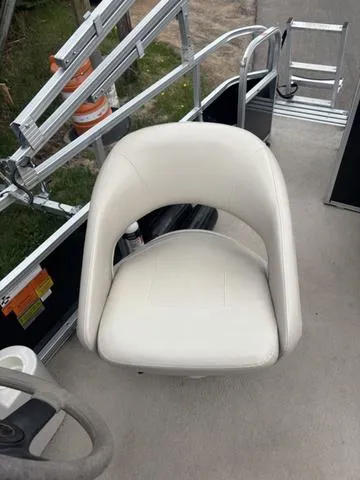 Slide: The Image of White seat on 2015 South Bay 420 CR boat deck, with railing and outdoor view. - 12