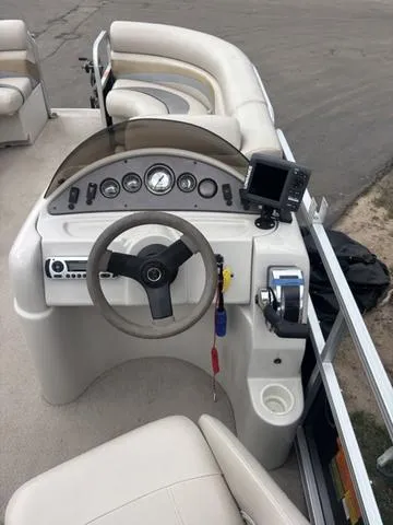 Slide: The Image of 2015 South Bay 420 CR boat dashboard with steering wheel and navigation controls. - 13