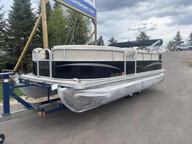 Slide: The Image of 2015 South Bay 420 CR pontoon boat on trailer, parked outdoors. - 2