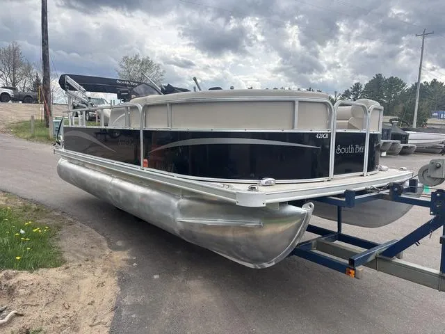 Slide: The Image of 2015 South Bay 420 CR pontoon boat on trailer under cloudy sky. - 4
