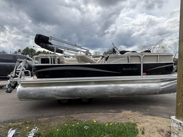 Slide: The Image of 2015 South Bay 420 CR pontoon boat on a trailer under cloudy skies. - 5