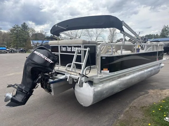 Slide: The Image of 2015 South Bay 420 CR pontoon boat with Mercury outboard motor, parked outdoors. - 6