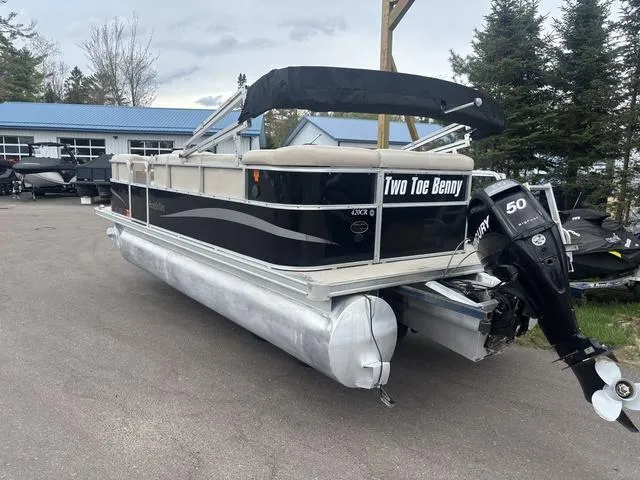 Slide: The Image of 2015 South Bay 420 CR pontoon boat with Mercury 50 HP engine, parked outdoors. - 8