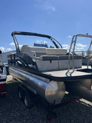 Slide: The Image of 2025 Harris SUNLINER 230 SLDH pontoon boat on trailer under clear blue sky. - 4
