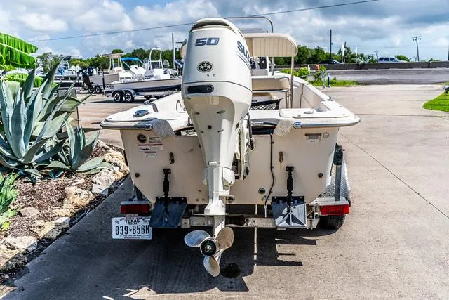 Slide: The Image of 2018 Carolina Skiff 16JVX boat with outboard motor on trailer, parked outdoors. - 4