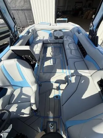 Slide: The Image of 2025 Centurion Fe25 boat interior with blue and gray seating, modern design. - 10