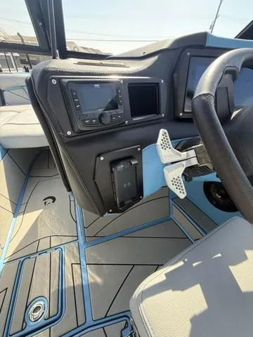 Slide: The Image of Interior of 2025 Centurion Fe25 boat with modern dashboard and steering wheel. - 15