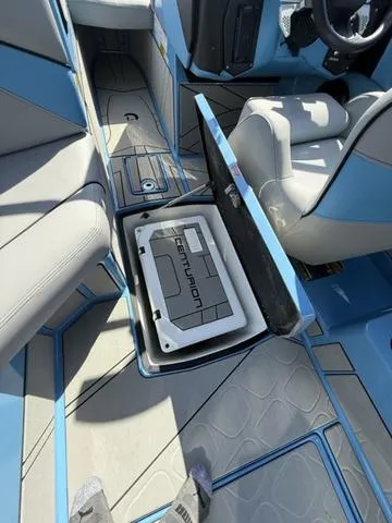Slide: The Image of 2025 Centurion Fe25 boat interior with open storage compartment and seating. - 8