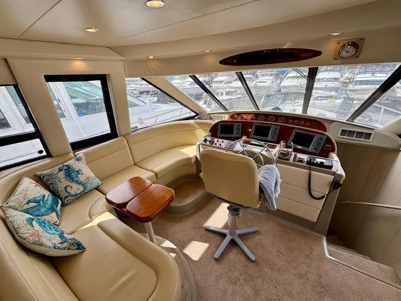 Slide: The Image of 1999 Bayliner 5288 Pilot House Motoryacht interior with helm, seating, and panoramic windows. - 13