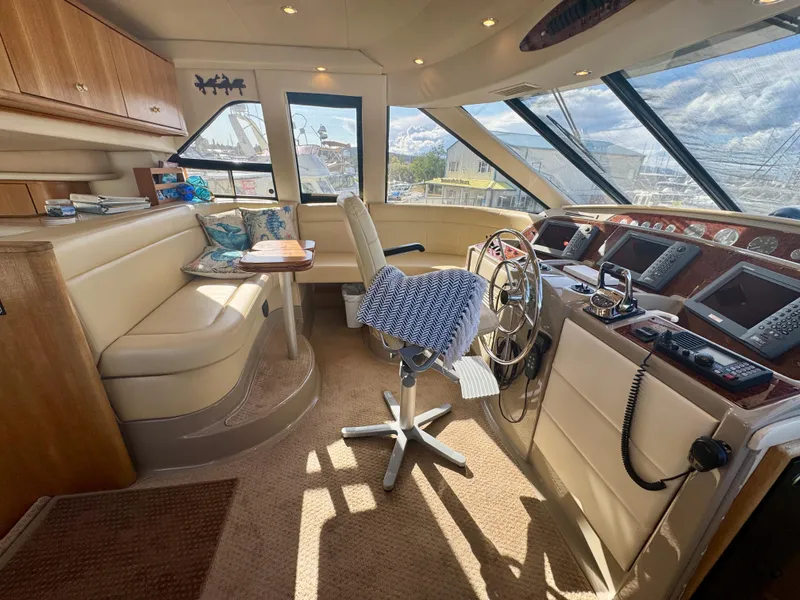 Slide: The Image of 1999 Bayliner 5288 Pilot House Motoryacht interior with helm, seating, and navigation equipment. - 14