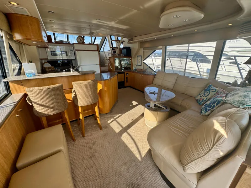 Slide: The Image of Luxurious interior of 1999 Bayliner 5288 Pilot House Motoryacht with spacious seating and kitchen area. - 2
