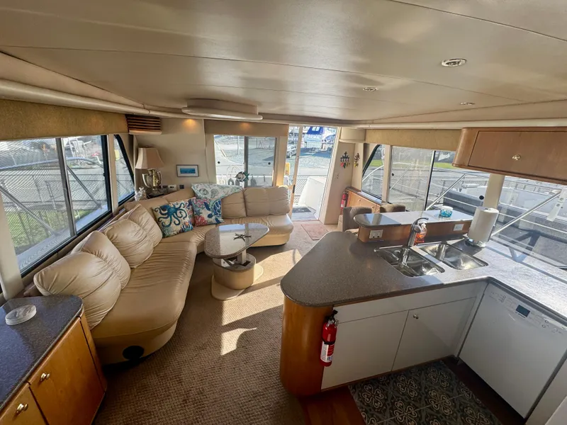 Slide: The Image of Luxurious interior of 1999 Bayliner 5288 Pilot House Motoryacht with spacious seating and modern kitchen. - 3