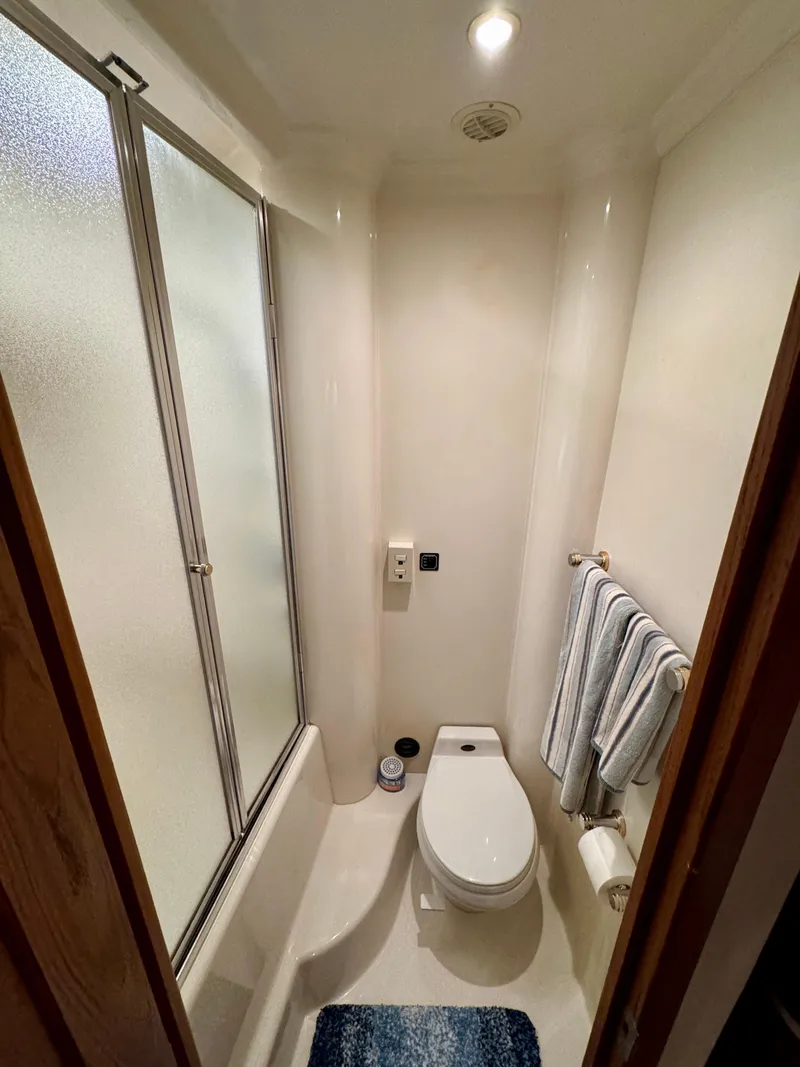 Slide: The Image of 1999 Bayliner 5288 Pilot House Motoryacht bathroom with shower and toilet. - 32