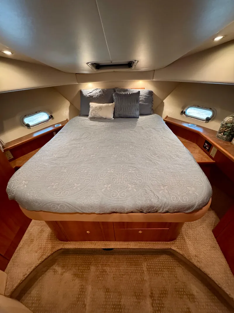 Slide: The Image of 1999 Bayliner 5288 Pilot House Motoryacht bedroom with cozy bed and elegant wood finish. - 36