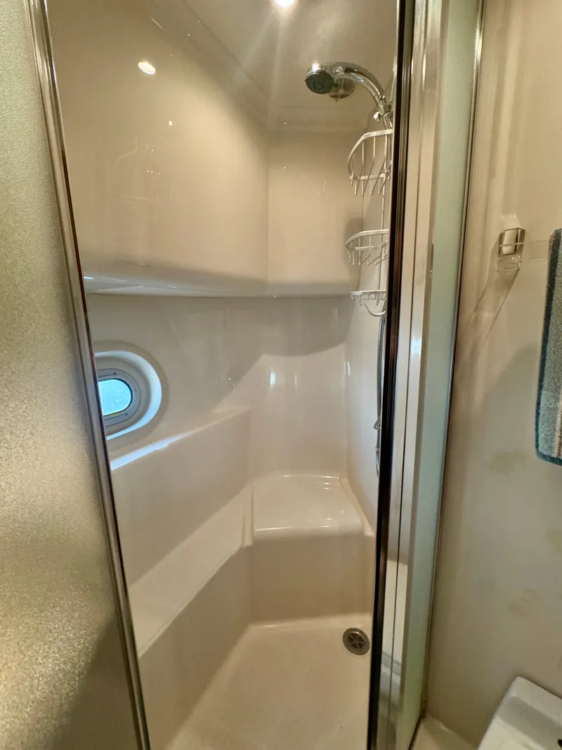 Slide: The Image of Shower area in 1999 Bayliner 5288 Pilot House Motoryacht with porthole and modern fixtures. - 39