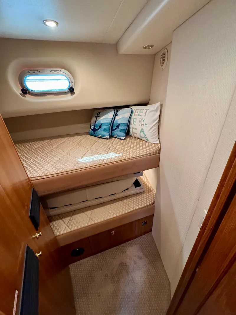 Slide: The Image of 1999 Bayliner 5288 Pilot House Motoryacht cabin with cozy bunk beds and nautical decor. - 40