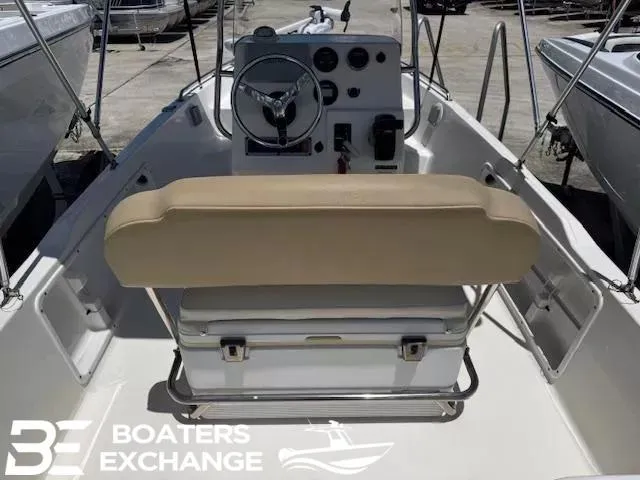Slide: The Image of 2017 Key West 1720 boat interior with steering console and beige seating. - 5