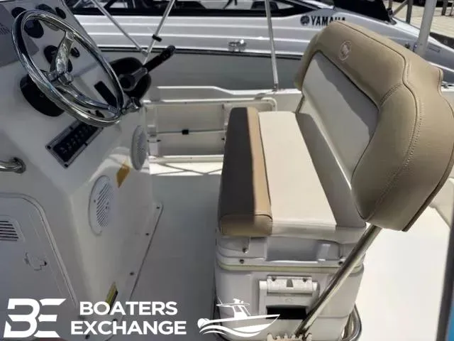 Slide: The Image of 2017 Key West 1720 boat interior with steering wheel and cushioned seating. - 6